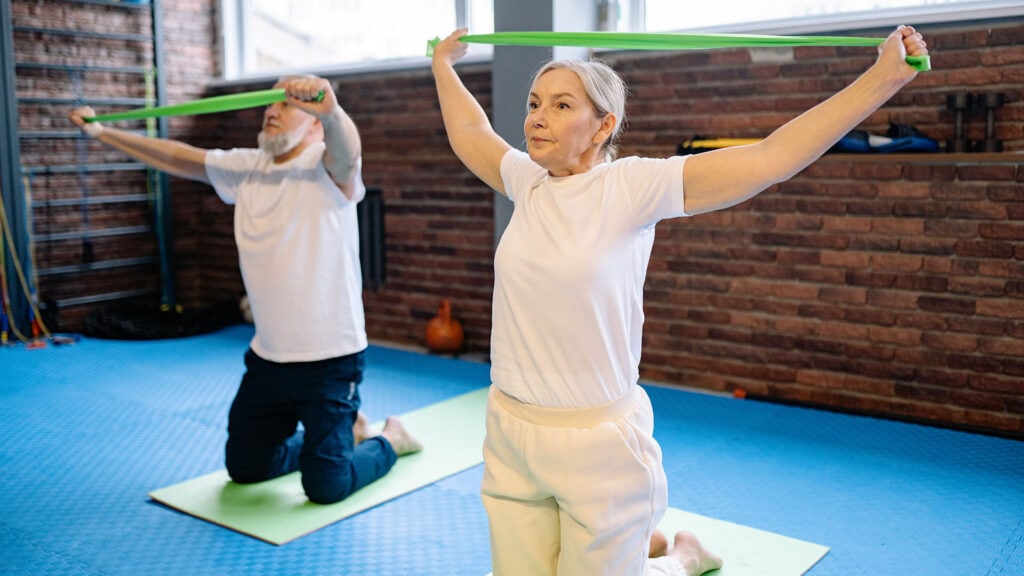 Senior couple exercising indoors during winter