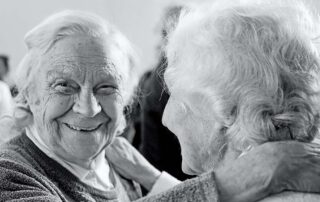Smiling seniors embracing and happy with senior living