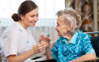 caregiver giving water to client during home care in-home services